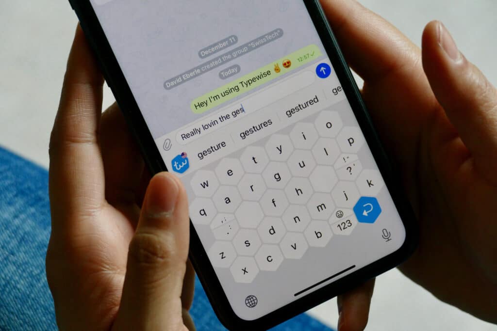 Mobile screen with hands texting about typewise