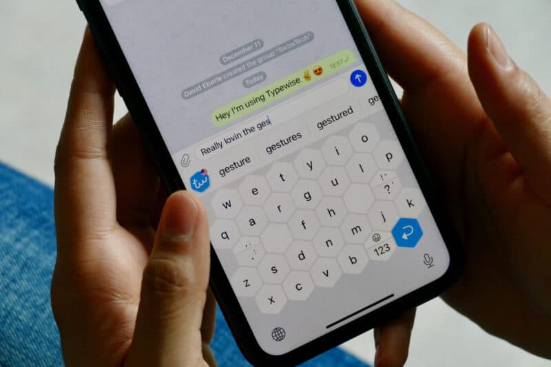 Mobile screen with hands texting about typewise